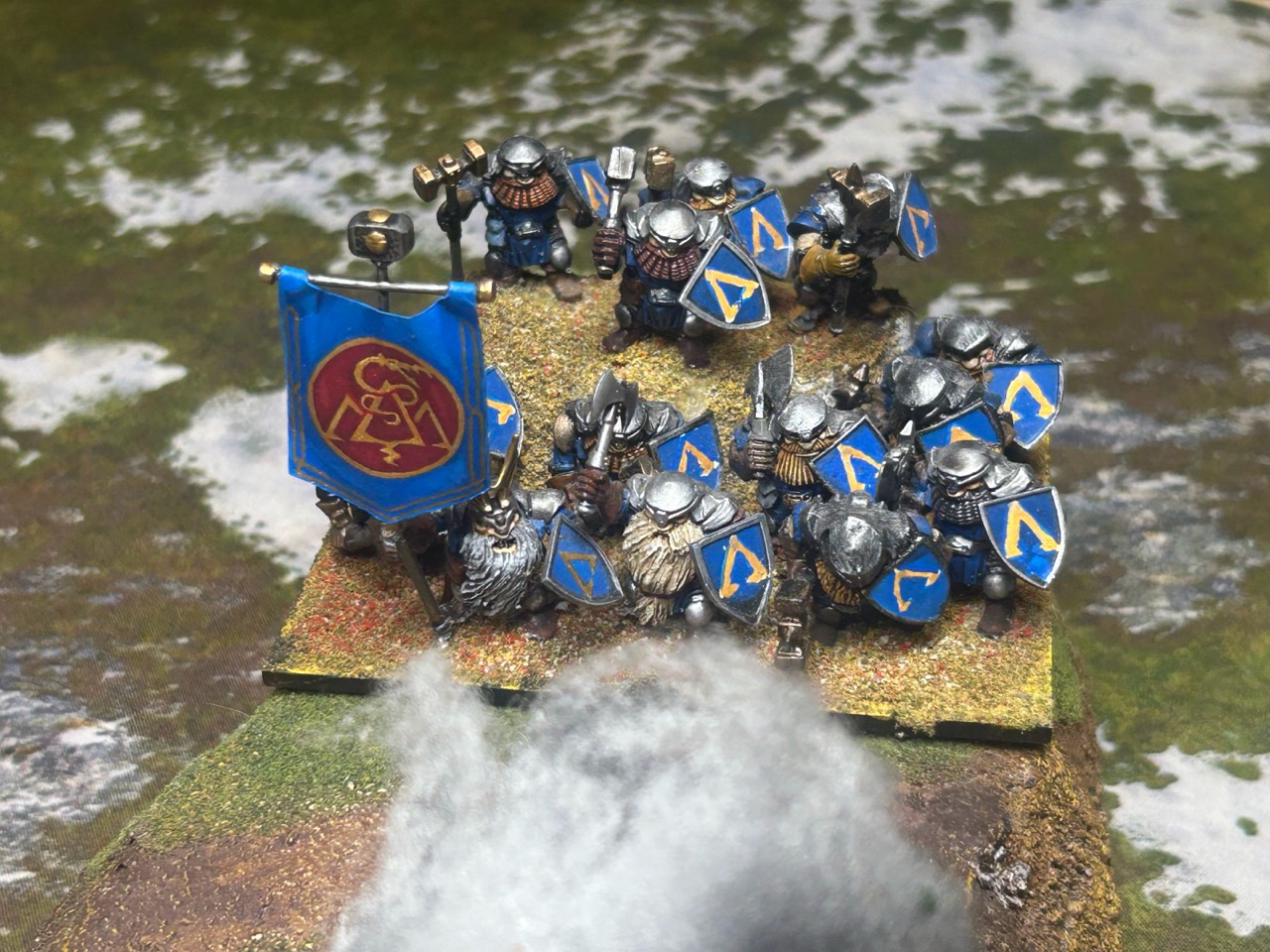 Client-supplied documentary reference showing infantry with blue shields, gold markings, and metallic armor.