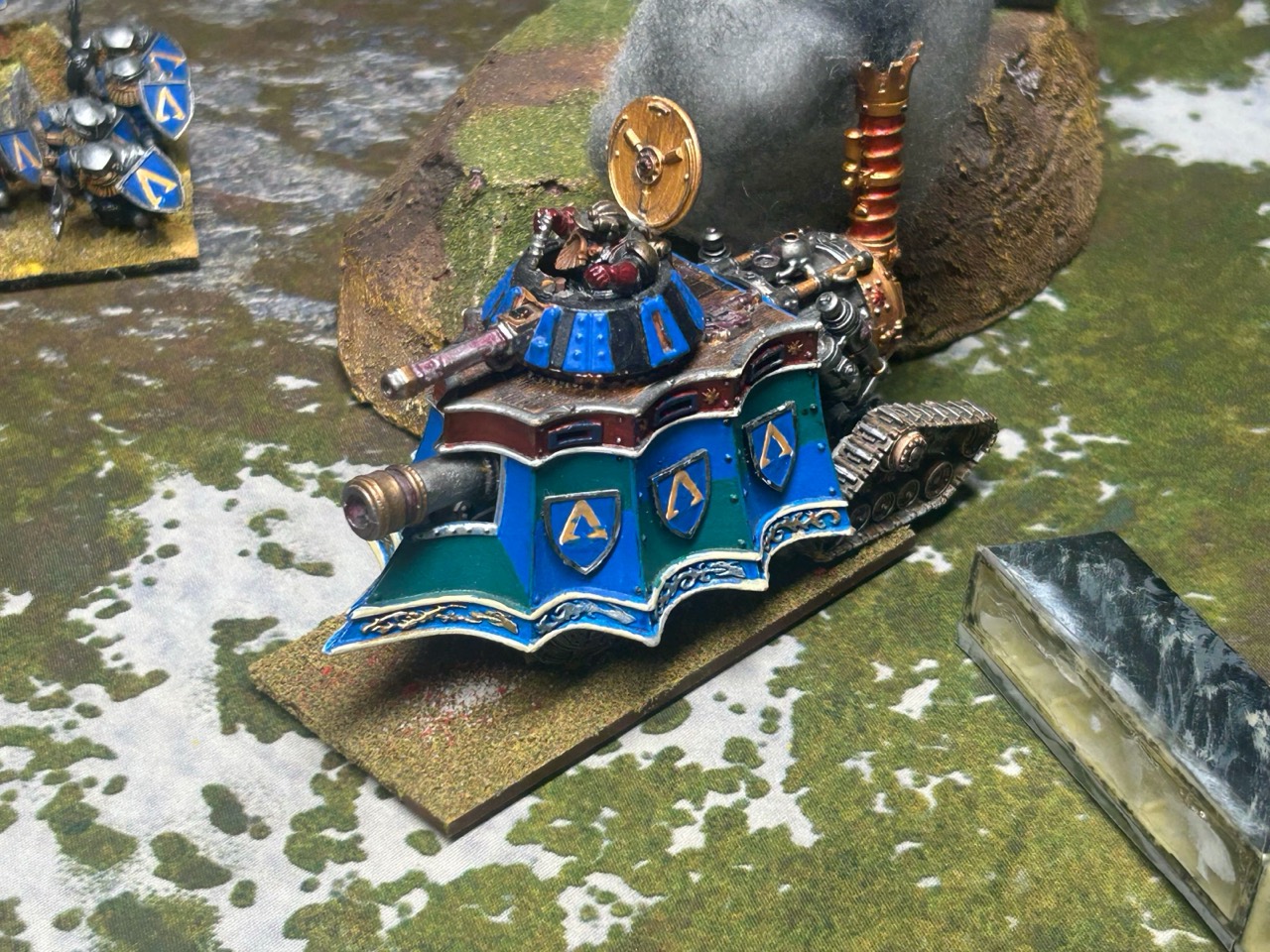 Client-supplied documentary reference showing an established blue and green armored vehicle scheme on the gaming table.